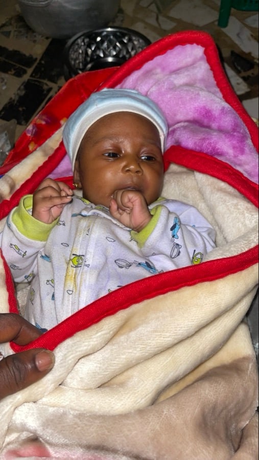 Baby wrapped in a soft blanket indoors